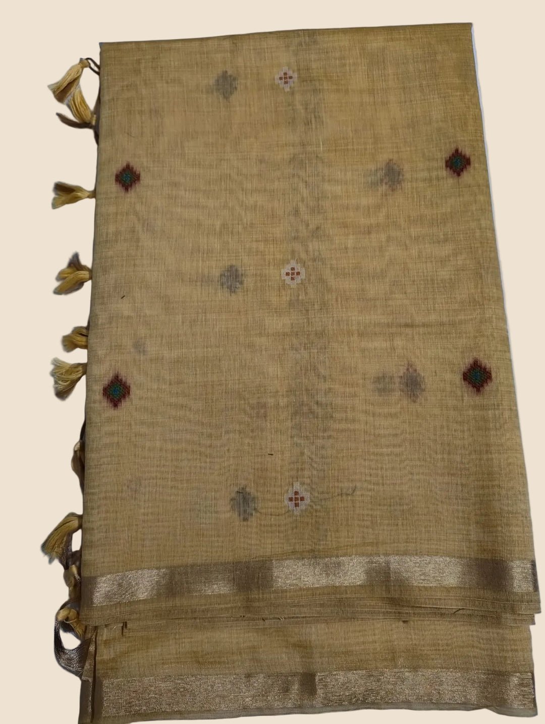 Textured fabric with decorative patterns and tassels on a light blue background