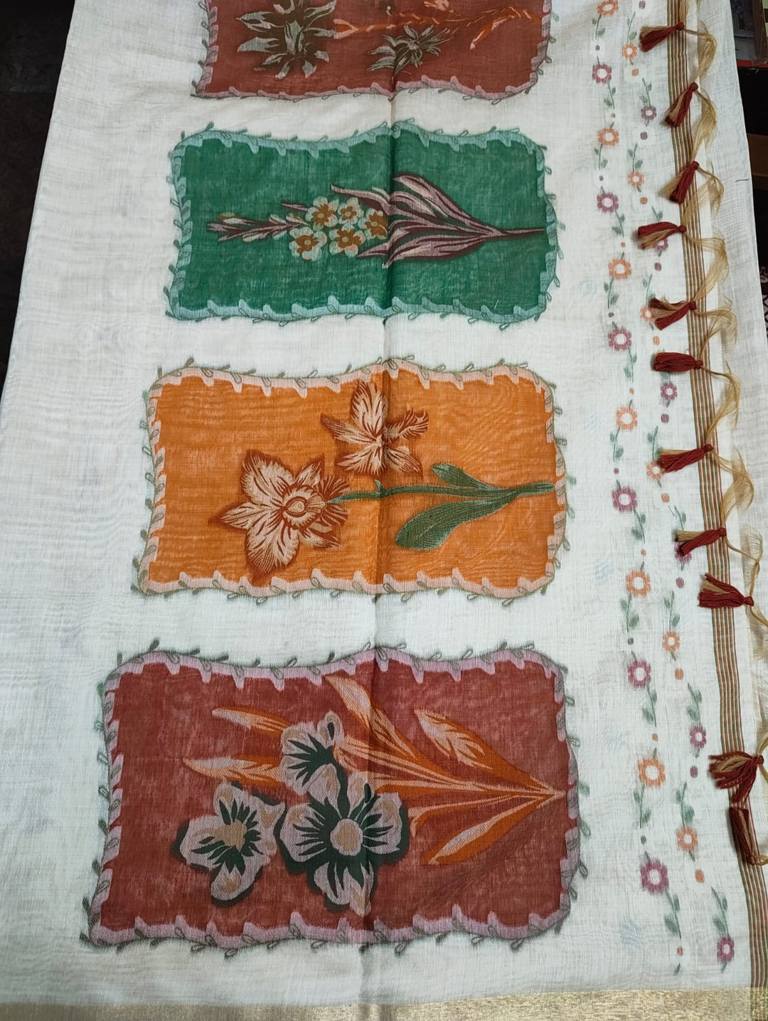 Decorative fabric with floral patterns and a border on a white background