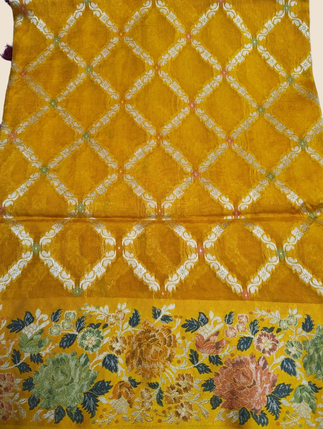 Yellow fabric with floral patterns and lattice design