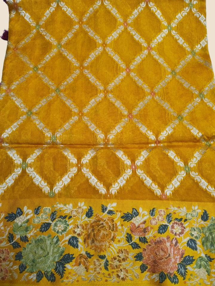 Yellow fabric with floral patterns and lattice design