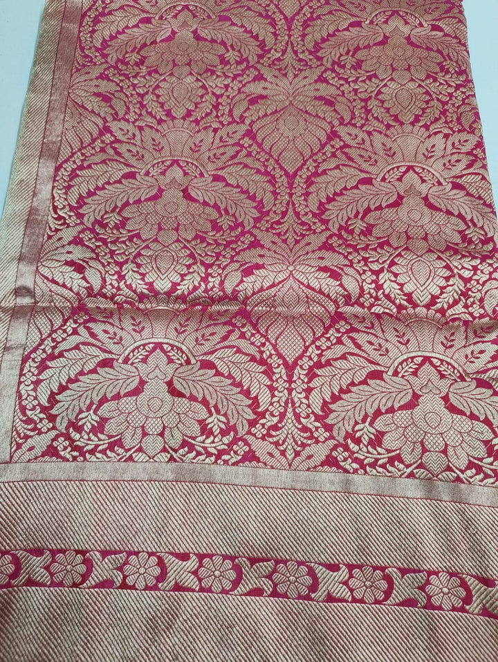 Textured fabric with pink and beige floral patterns on a light blue background