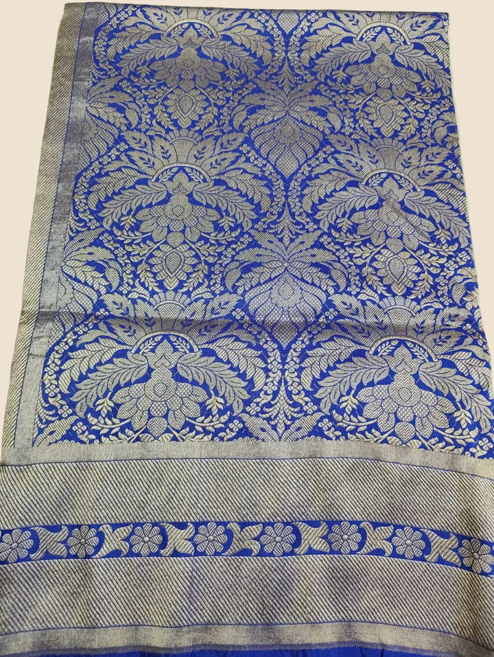 Decorative fabric with blue and silver floral patterns on a white background