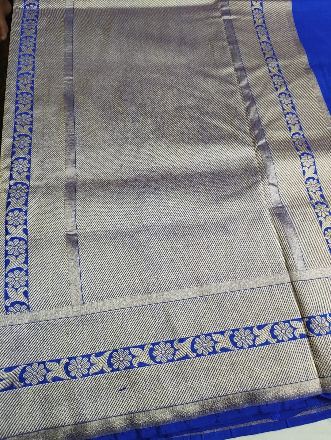 Gray fabric with blue and white border patterns