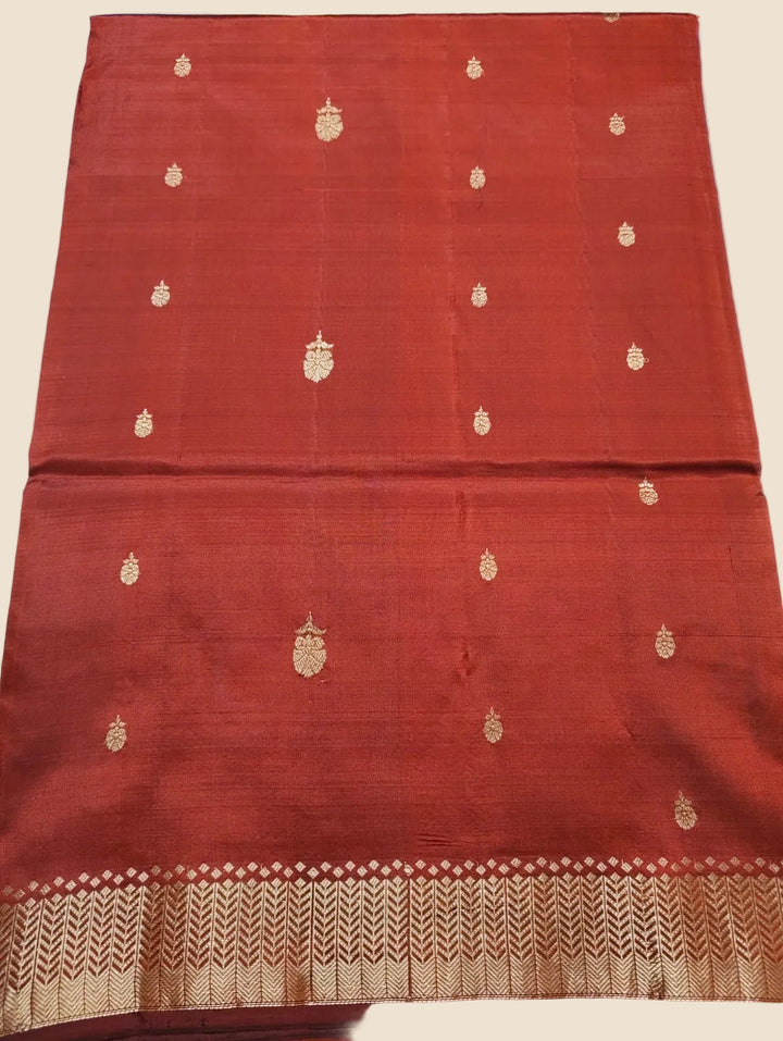 Red fabric with gold embroidery on a light blue background