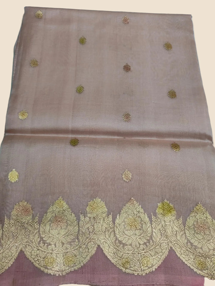 Brown fabric with gold embroidery on a light blue background