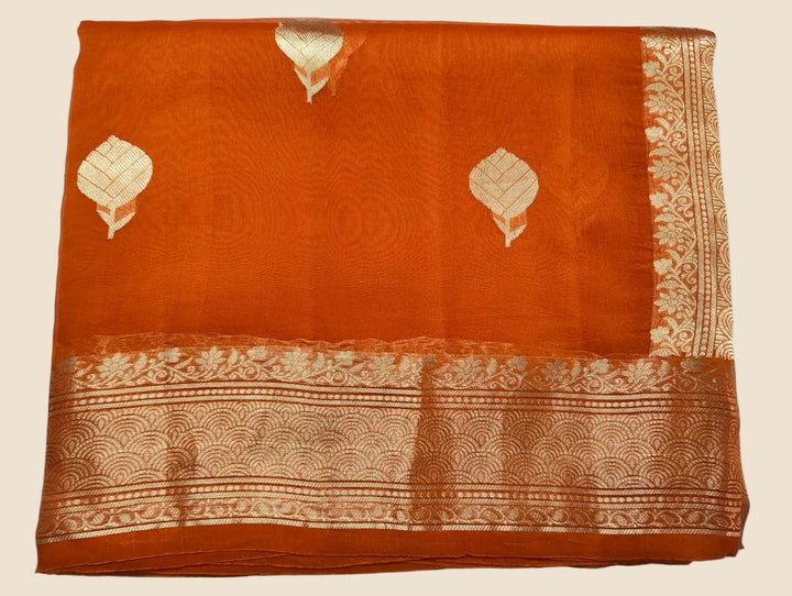 Orange fabric with white patterns on a light blue background
