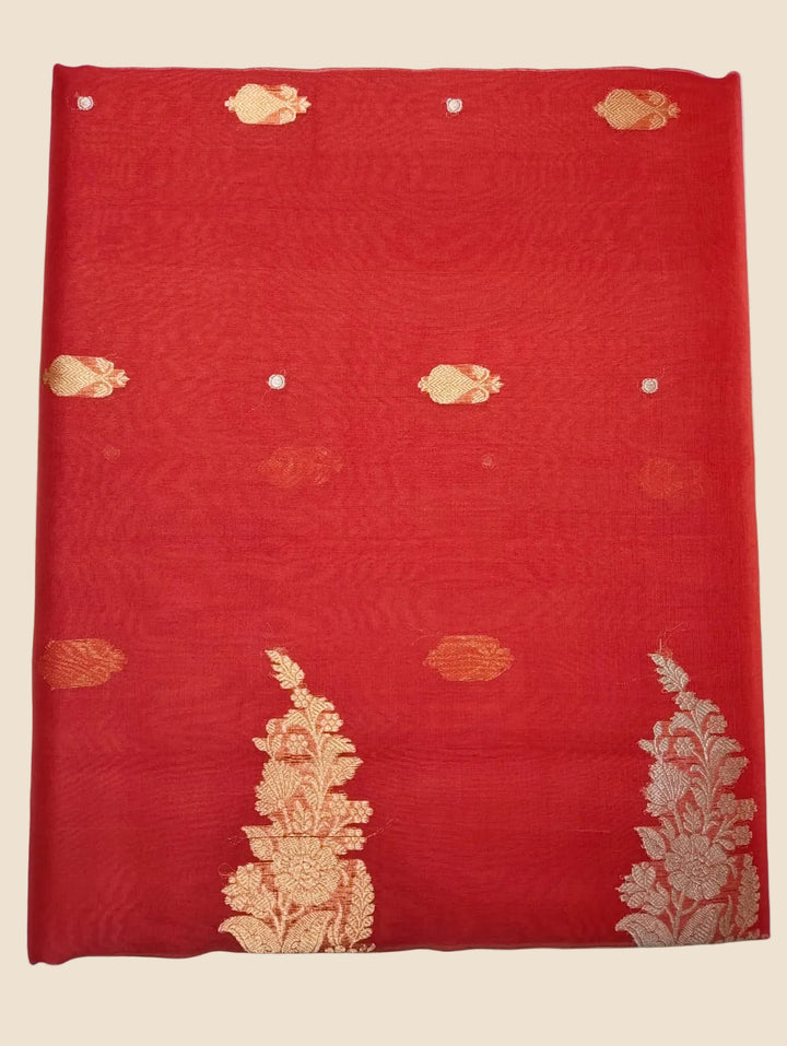Red fabric with gold embroidery on a white background