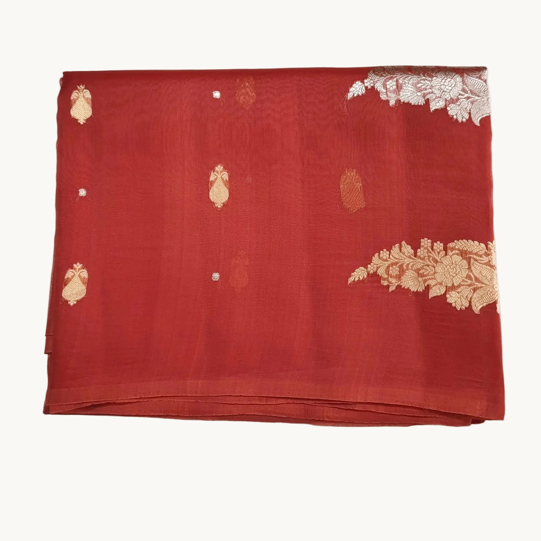 Red fabric with gold embroidery on a white background