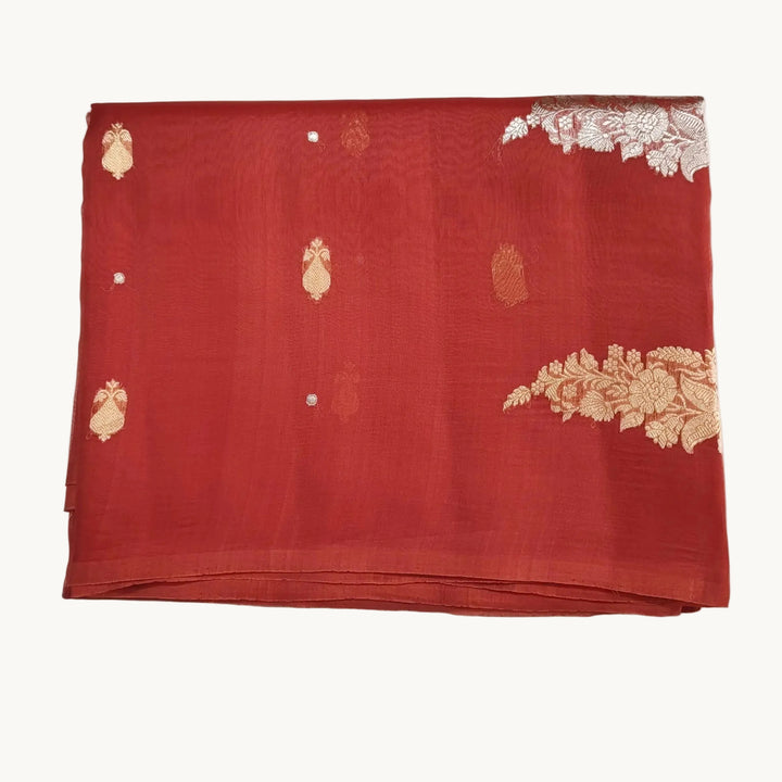 Red fabric with gold embroidery on a white background