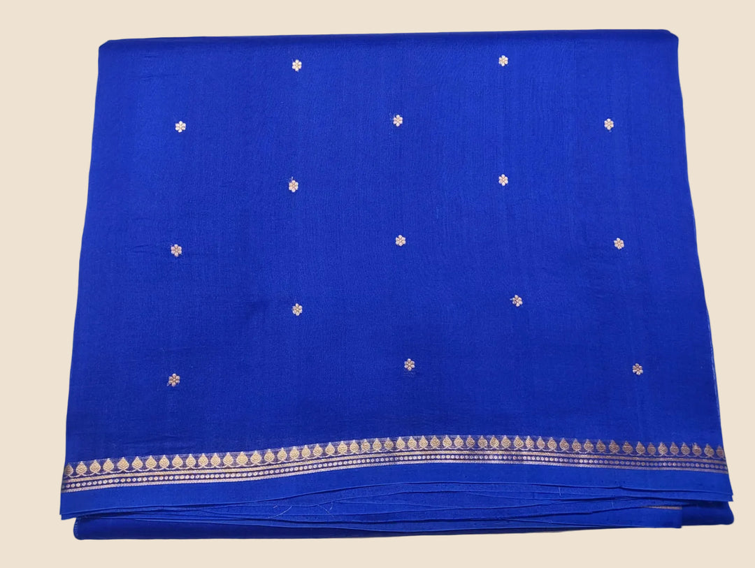 Blue fabric with white floral patterns on a light gray background