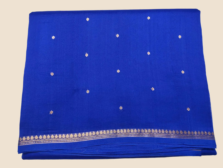 Blue fabric with white floral patterns on a light gray background