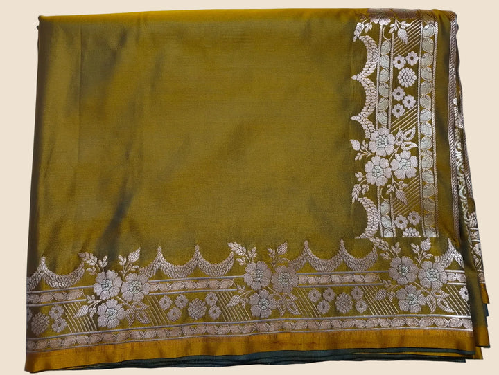 Mustard yellow fabric with white floral embroidery on a light gray background