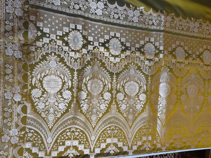 Decorative fabric with intricate gold and white pattern