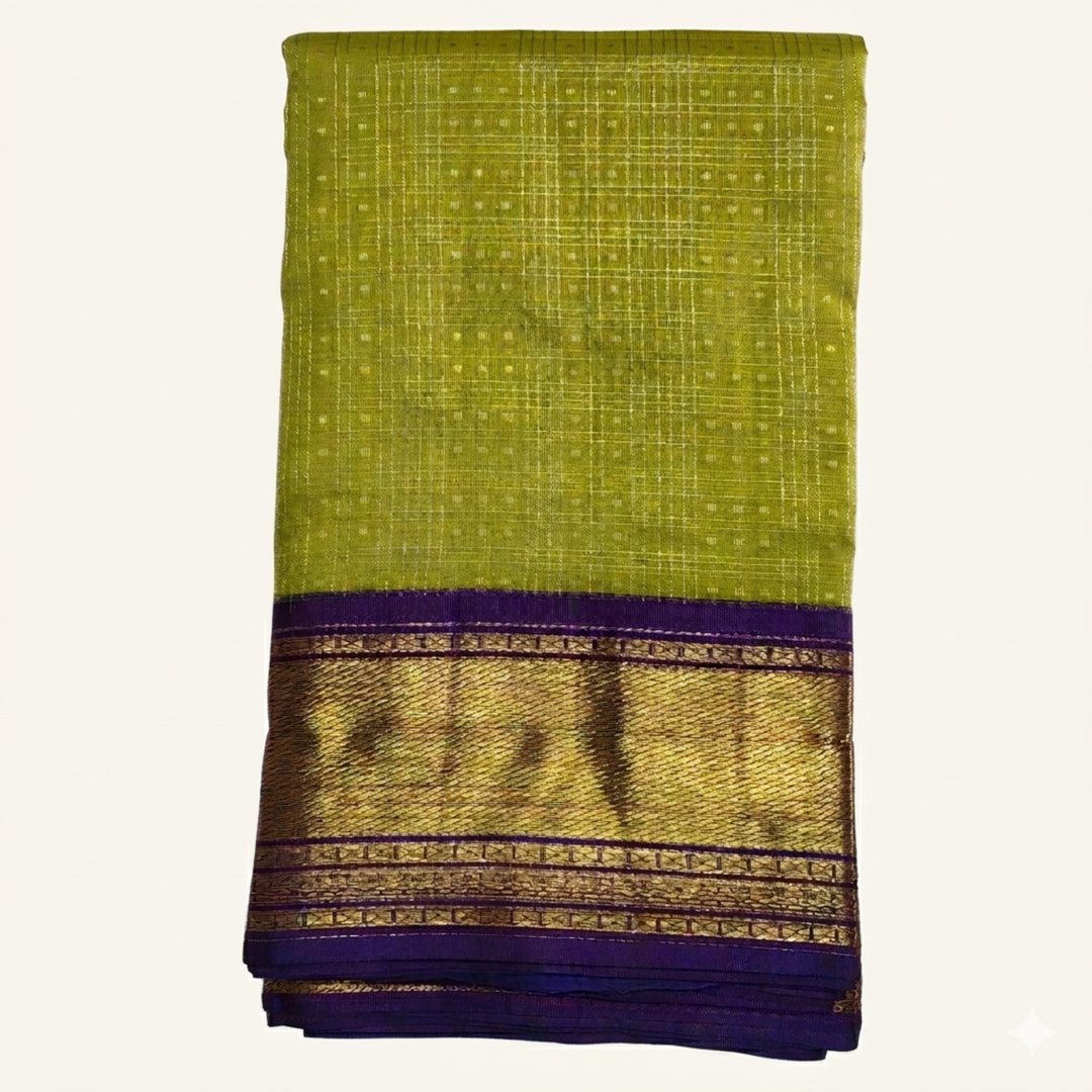 Green saree with a purple and gold border on a white background