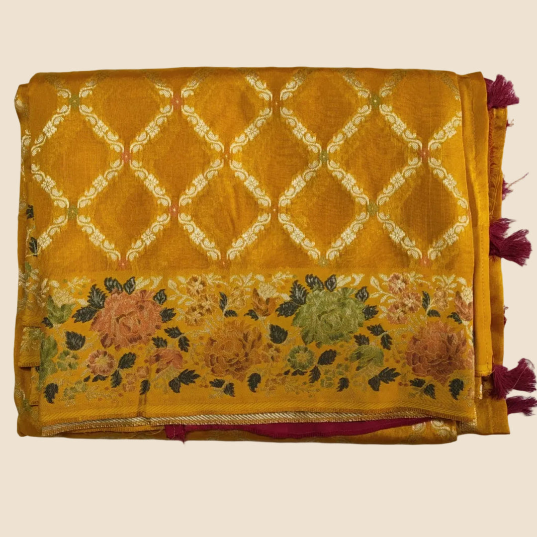 Yellow fabric with floral and geometric patterns on a white background