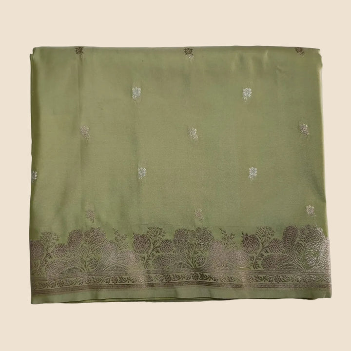 Green fabric with lace trim on a white background