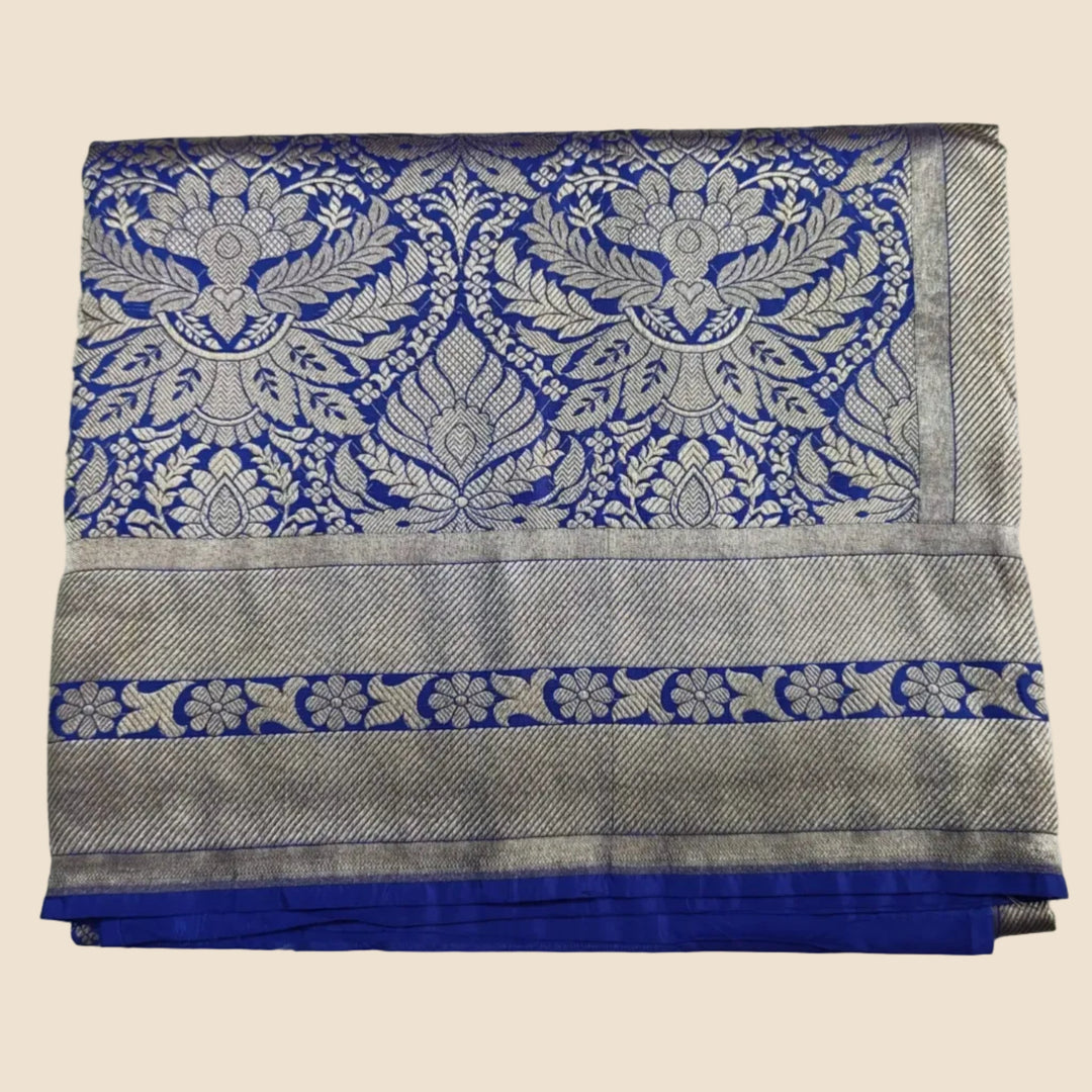 Folded fabric with blue and silver pattern on a white background