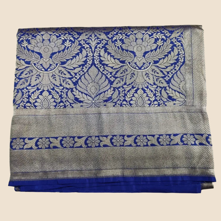 Folded fabric with blue and silver pattern on a white background