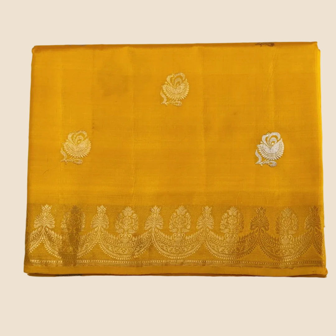 Yellow fabric with white embroidery on a gray background