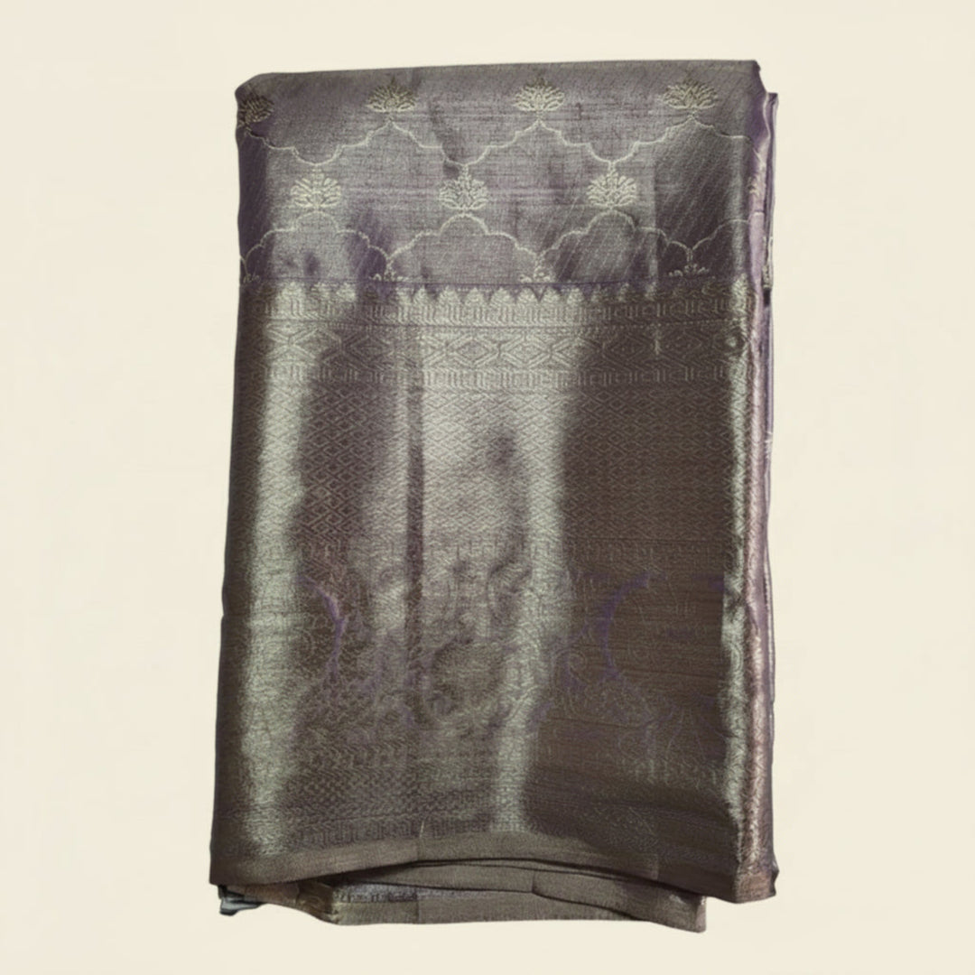 Folded fabric with intricate patterns on a light gray background