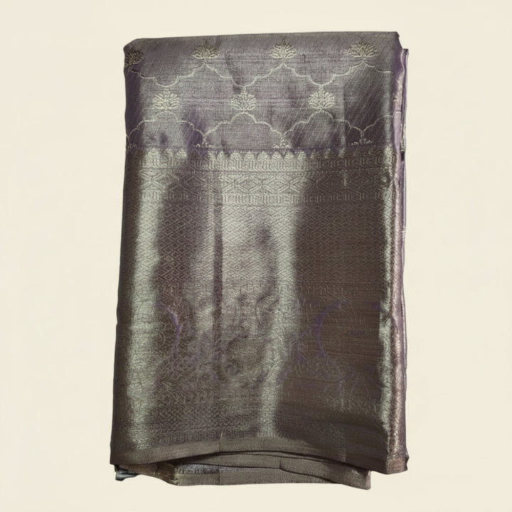 Folded fabric with intricate patterns on a light gray background