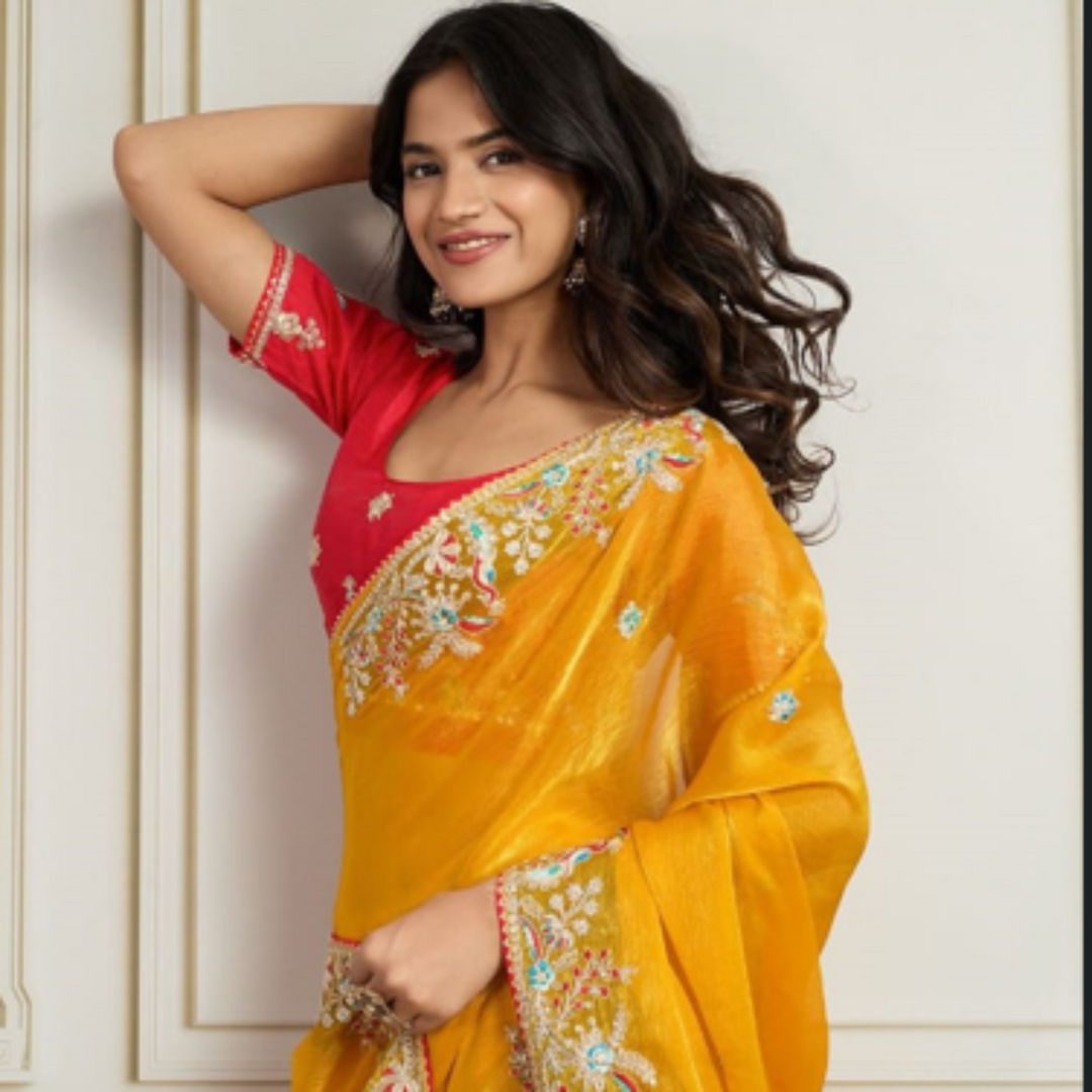 Woman wearing a yellow saree with floral patterns